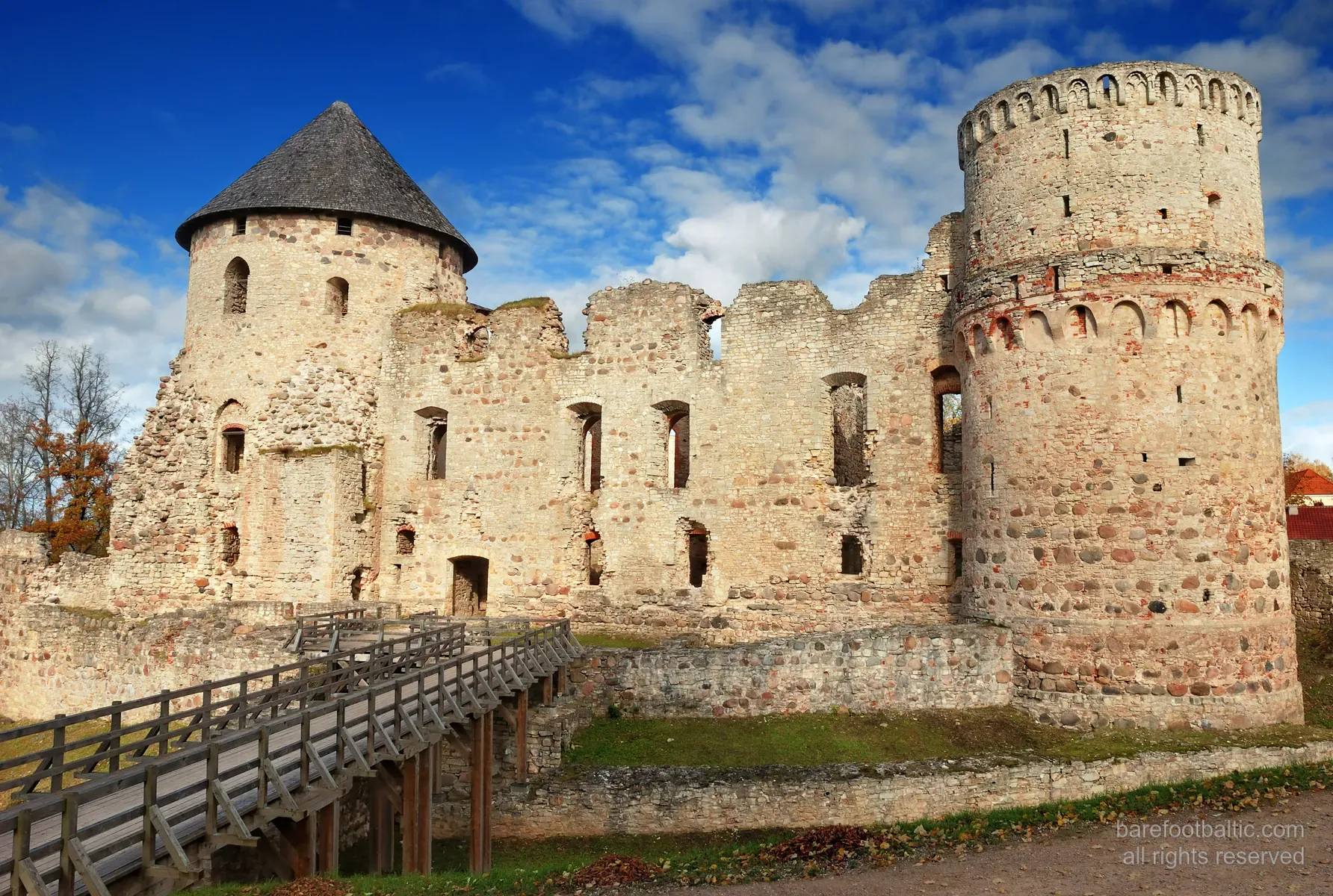 Exterior of the medieval Cēsis Castle, red brick walls in autumn light, Latvia