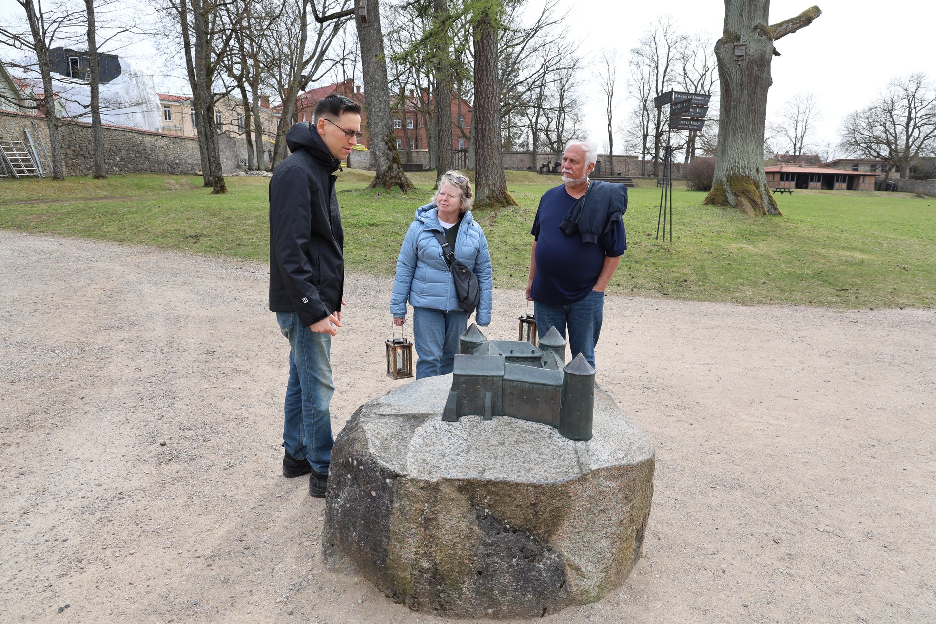 Tactile bronze model of Cēsis Castle, with guests on the walking tour