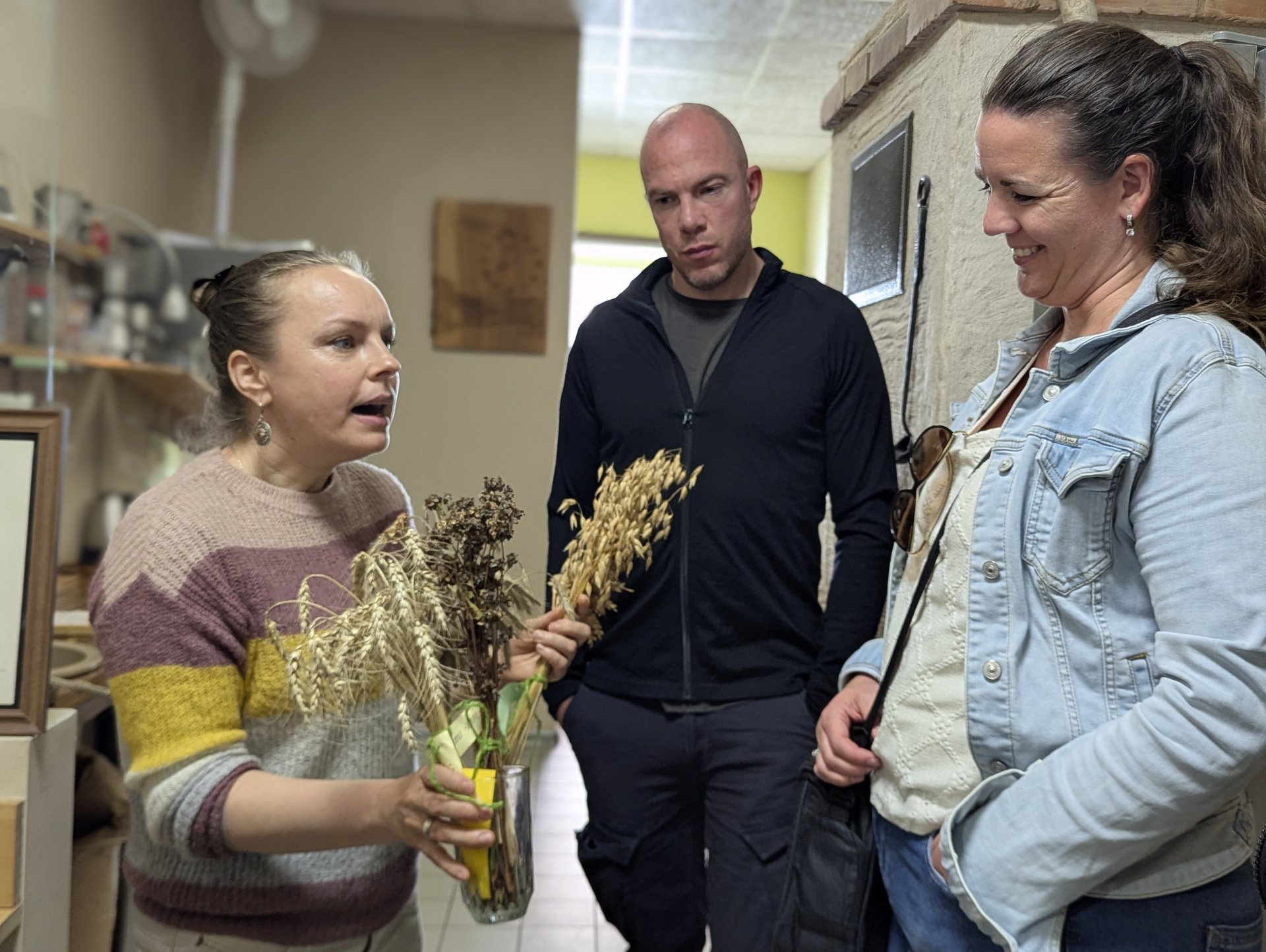 Grain-stalks demonstration to guests inside the Cēsu Maize bakery