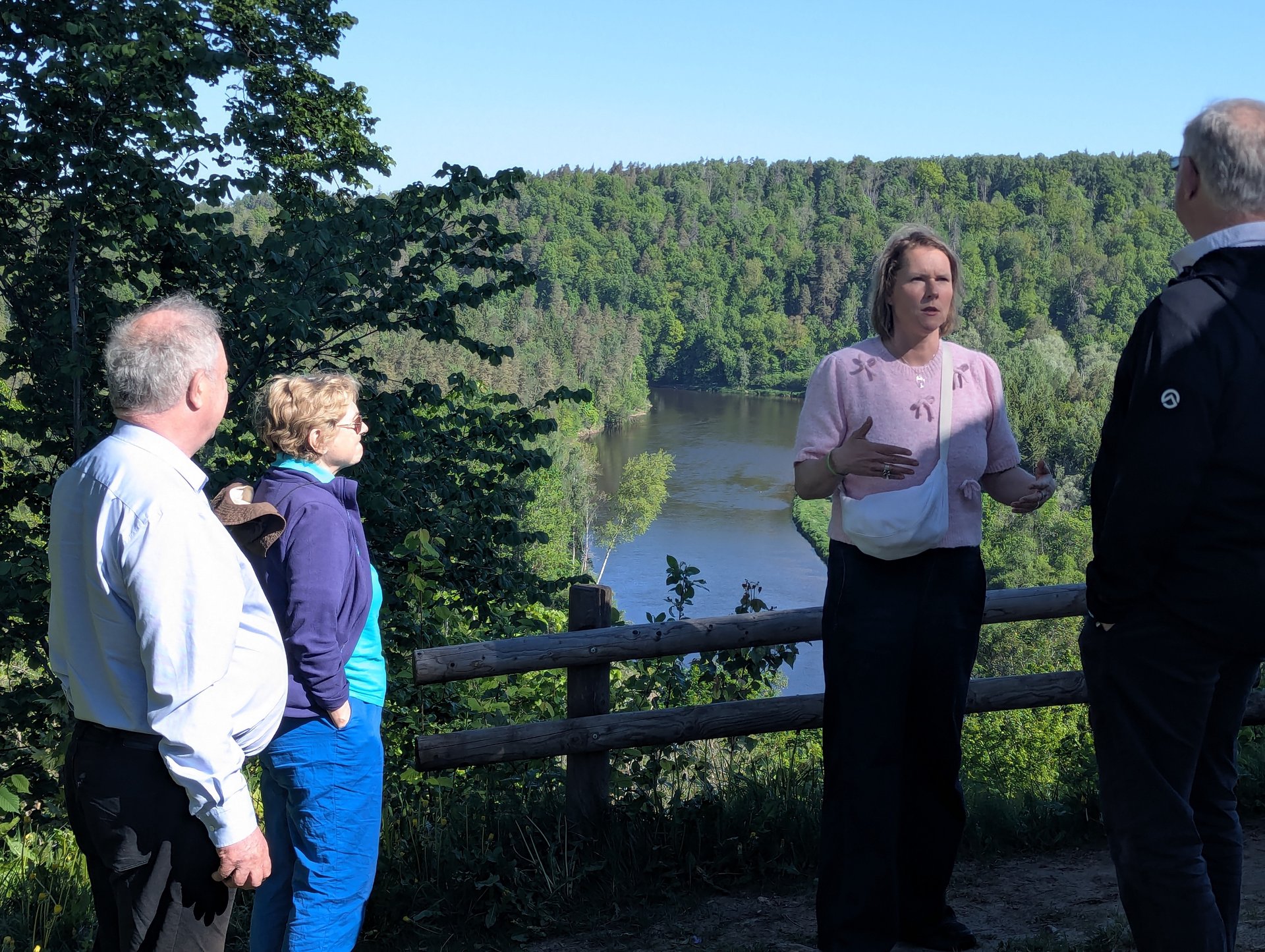 Daiga explaining at a Gauja Valley overlook with a small tour group