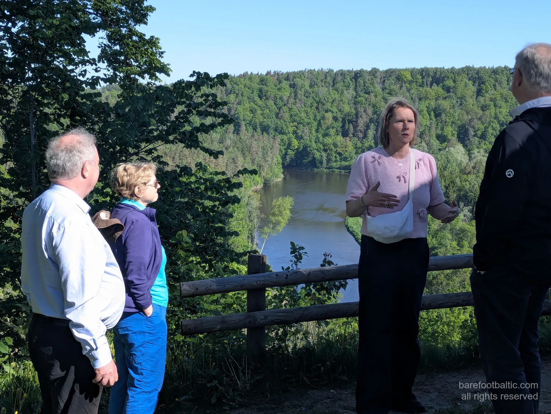 Daiga explaining at a Gauja Valley overlook with a small tour group