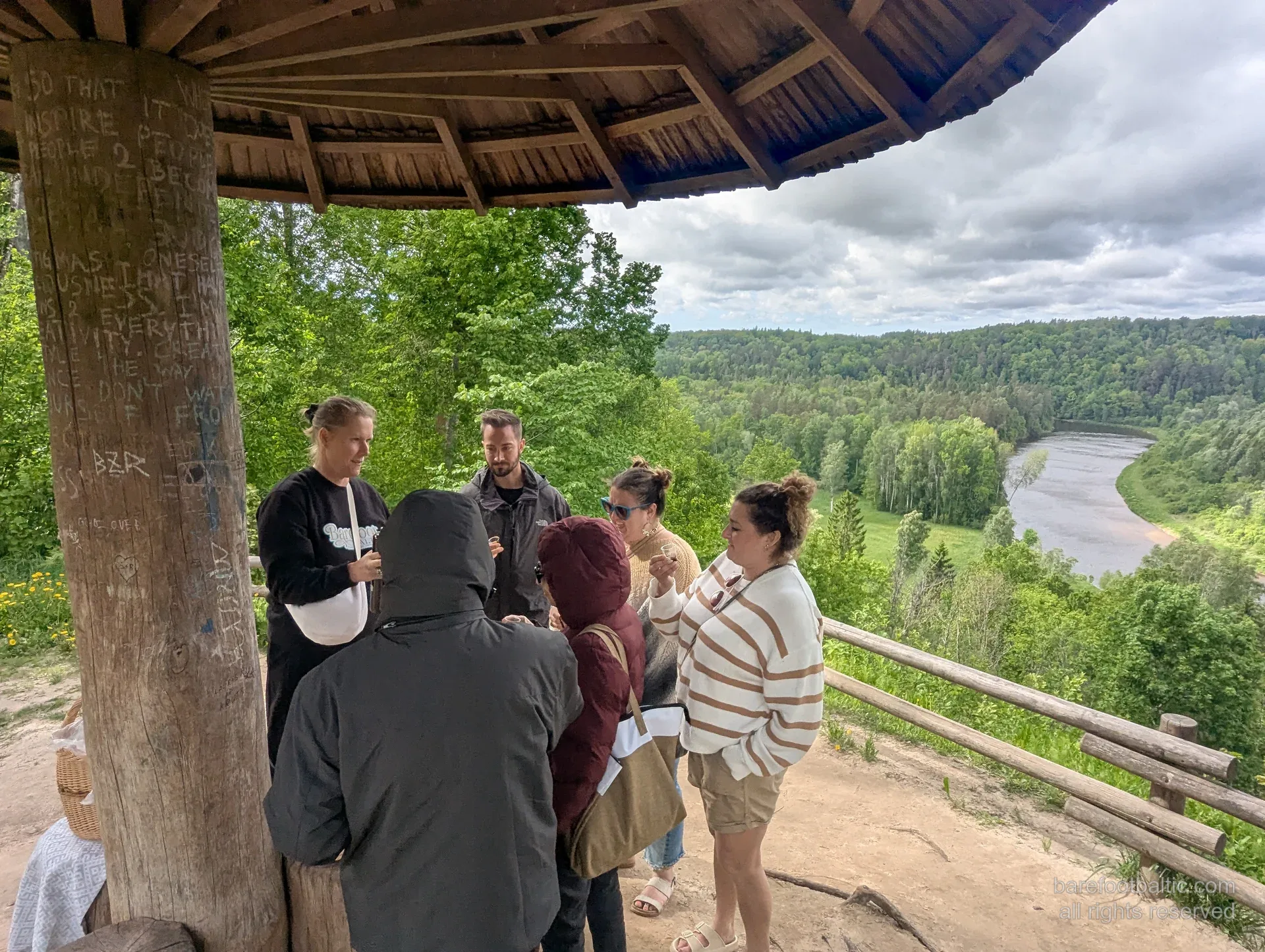 Tour group at the Painters&rsquo; Hill wooden overlook gazebo above the Gauja Valley