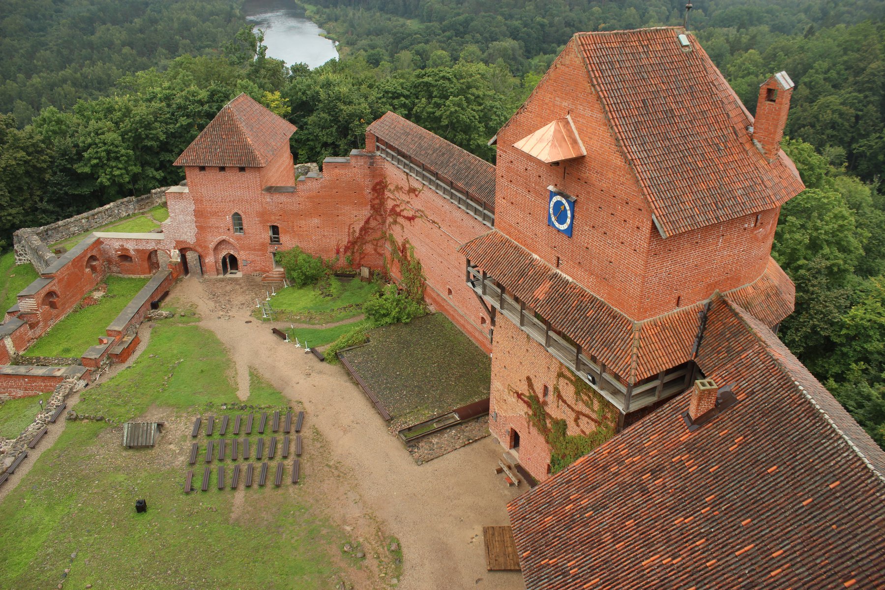 Aerial view of Turaida Castle's red-brick walls above the Gauja Valley