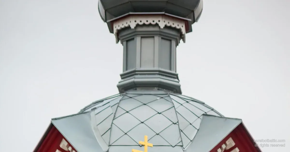A wooden Orthodox church with onion dome and the eight-pointed three-bar Orthodox cross — Latvia.